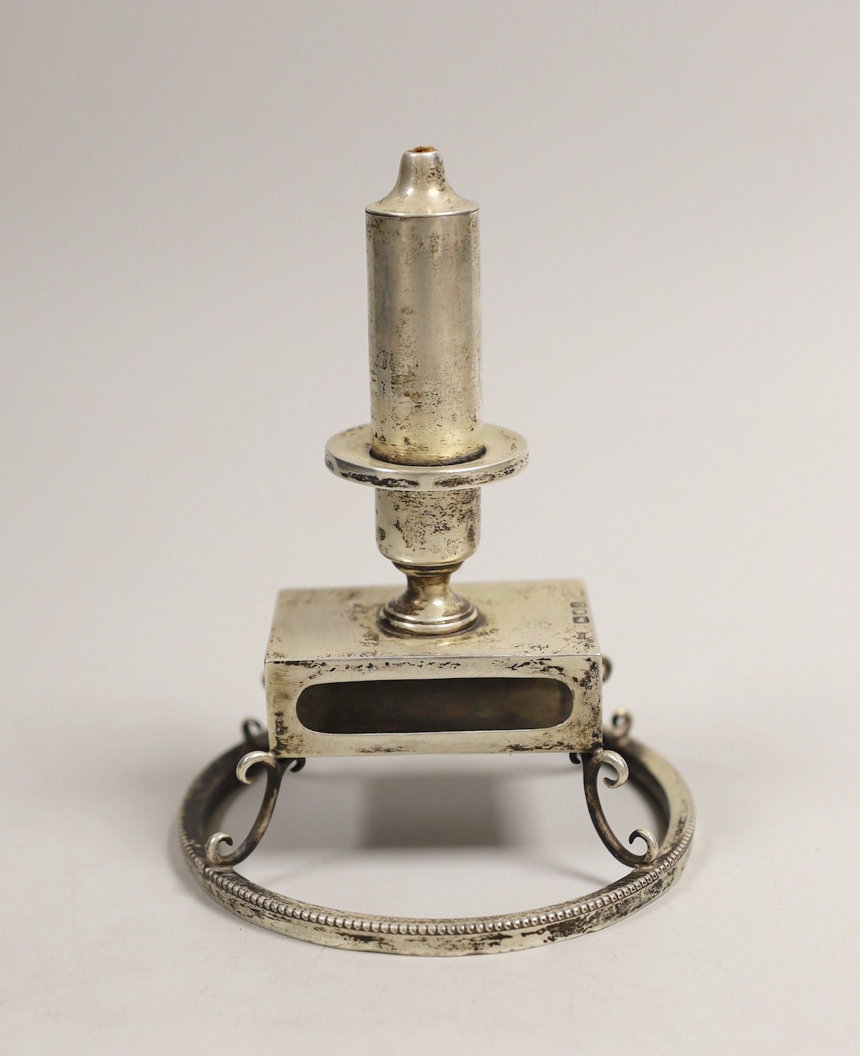 A late Victorian silver combination cigar lighter and matchbox holder, on circular foot, Grey & Co, London, 1899, base diameter 10.2cm.